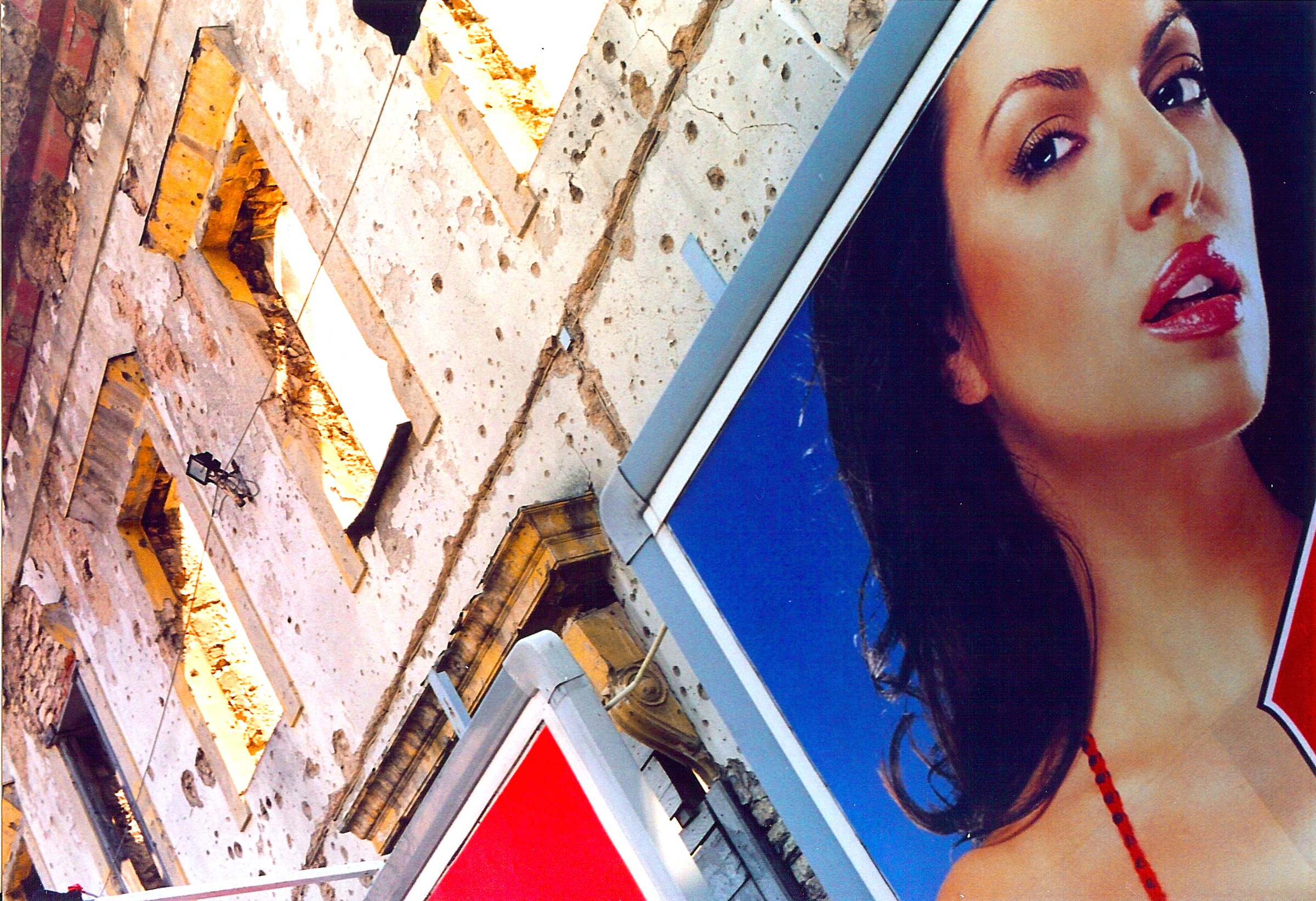 Commercial billboard on war-damaged building in Mostar, Bosnia (Photo: il desiderio di una vita normale)