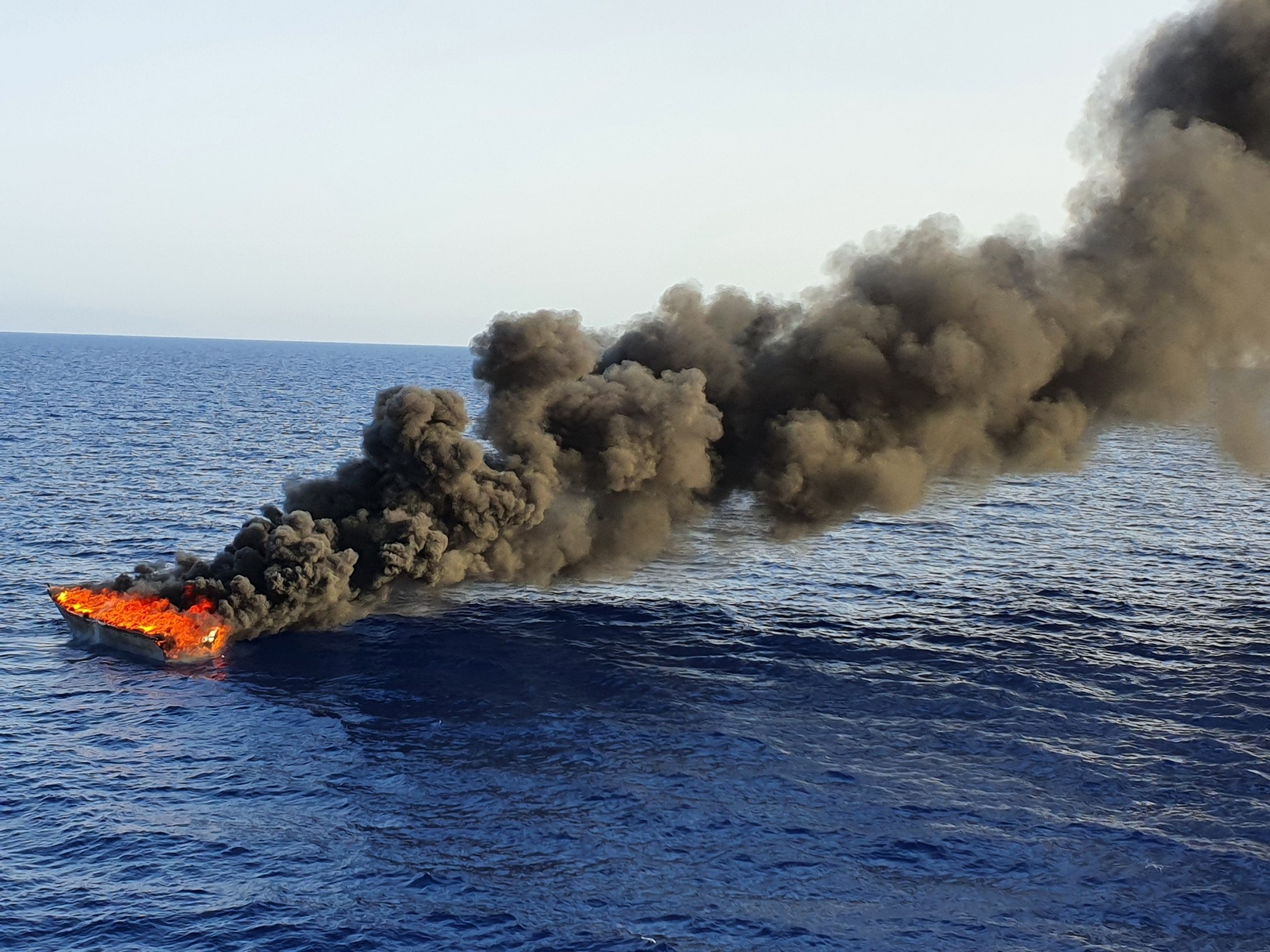 The Libyan coast guard sets fire to a boat used by people trying to reach Europe <a target="_blank">(Photo: Nikolaj Nielsen)</a>