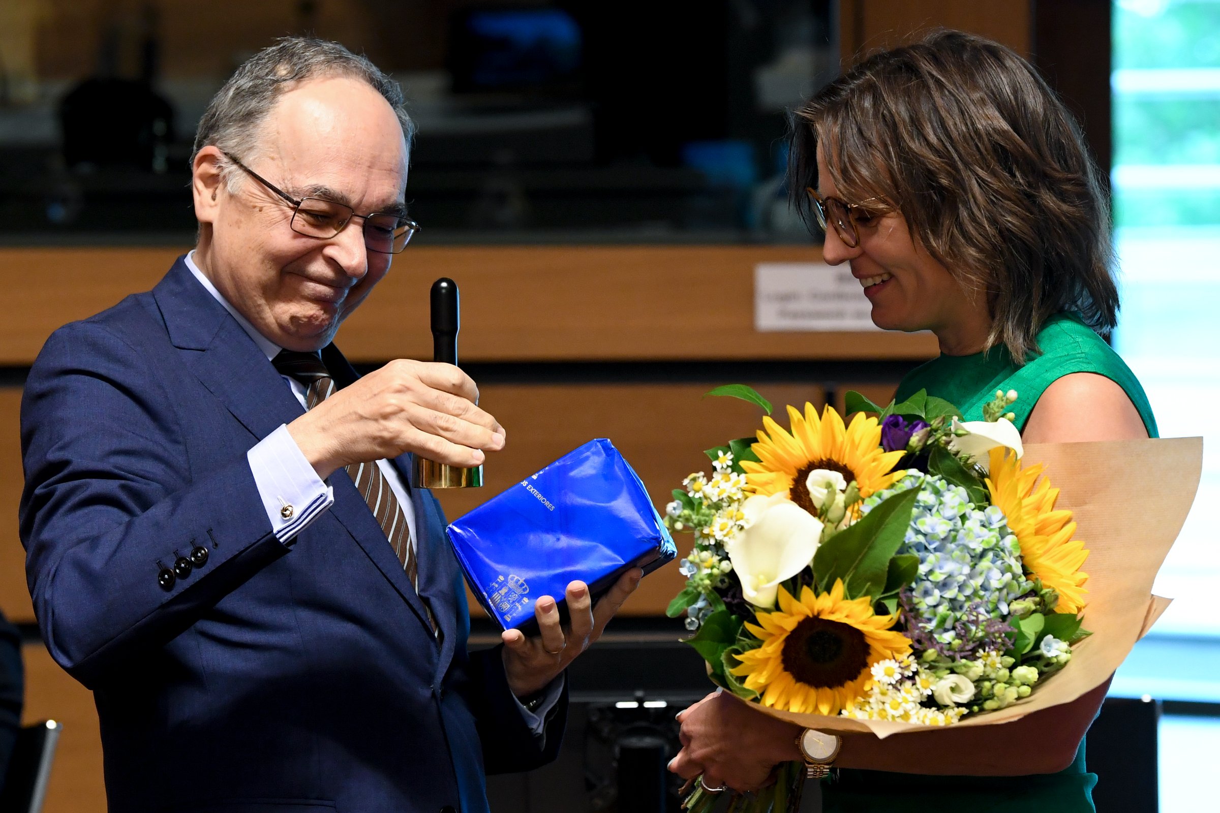 Spanish state secretary of EU affairs, Pascual Ignacio Navarro Rios hands a bouquet to Swedish EU affairs minister Jessika Roswall as his country takes over the EU's rotating presidency from July (Photo: Council of the European Union)