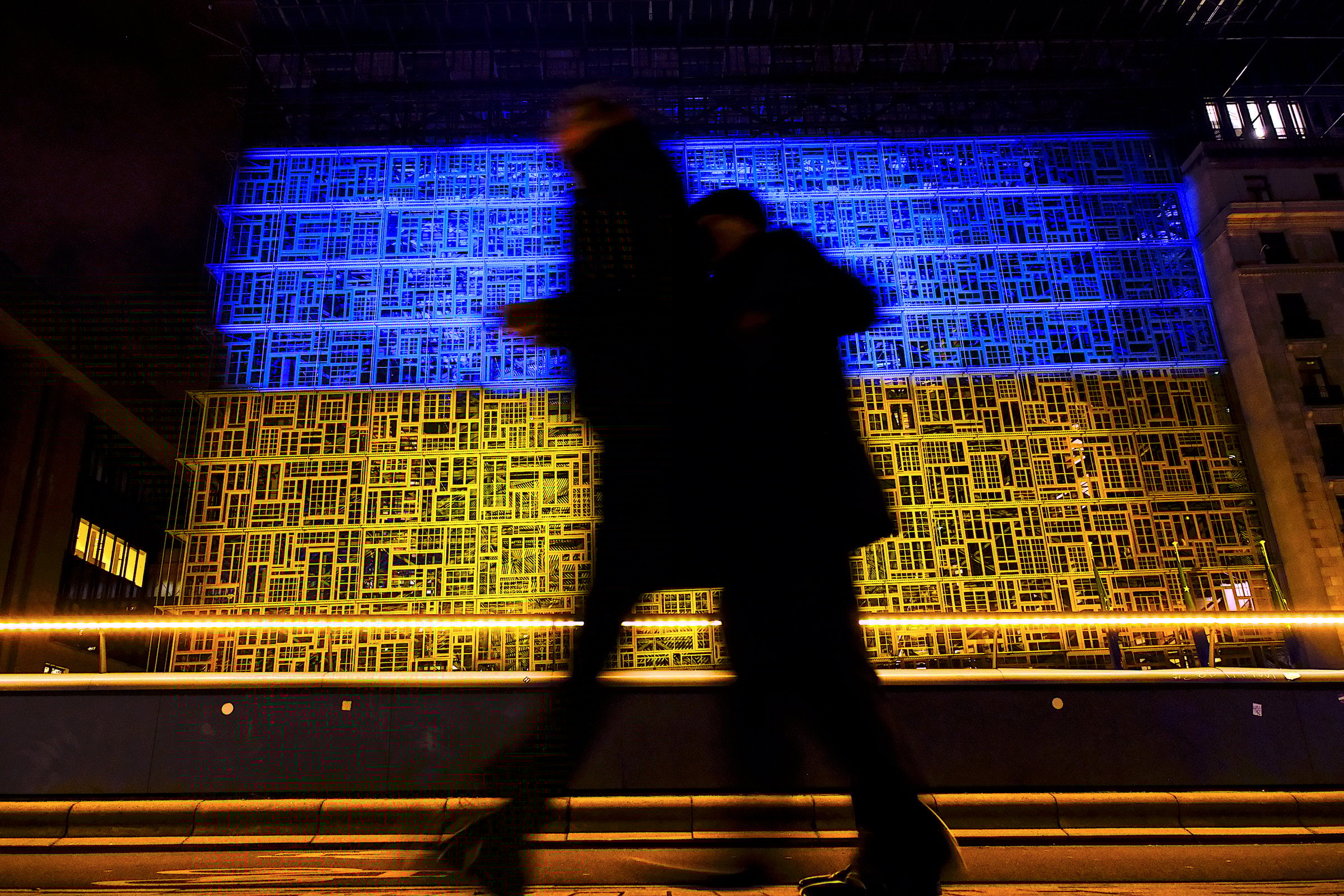 The EU Council building in Brussels — illuminated in the yellow-and-blue colours of the Ukrainian flag on 24 February 2025 to mark the third anniversary of Russia's full-scale invasion  (Photo: EU Council)