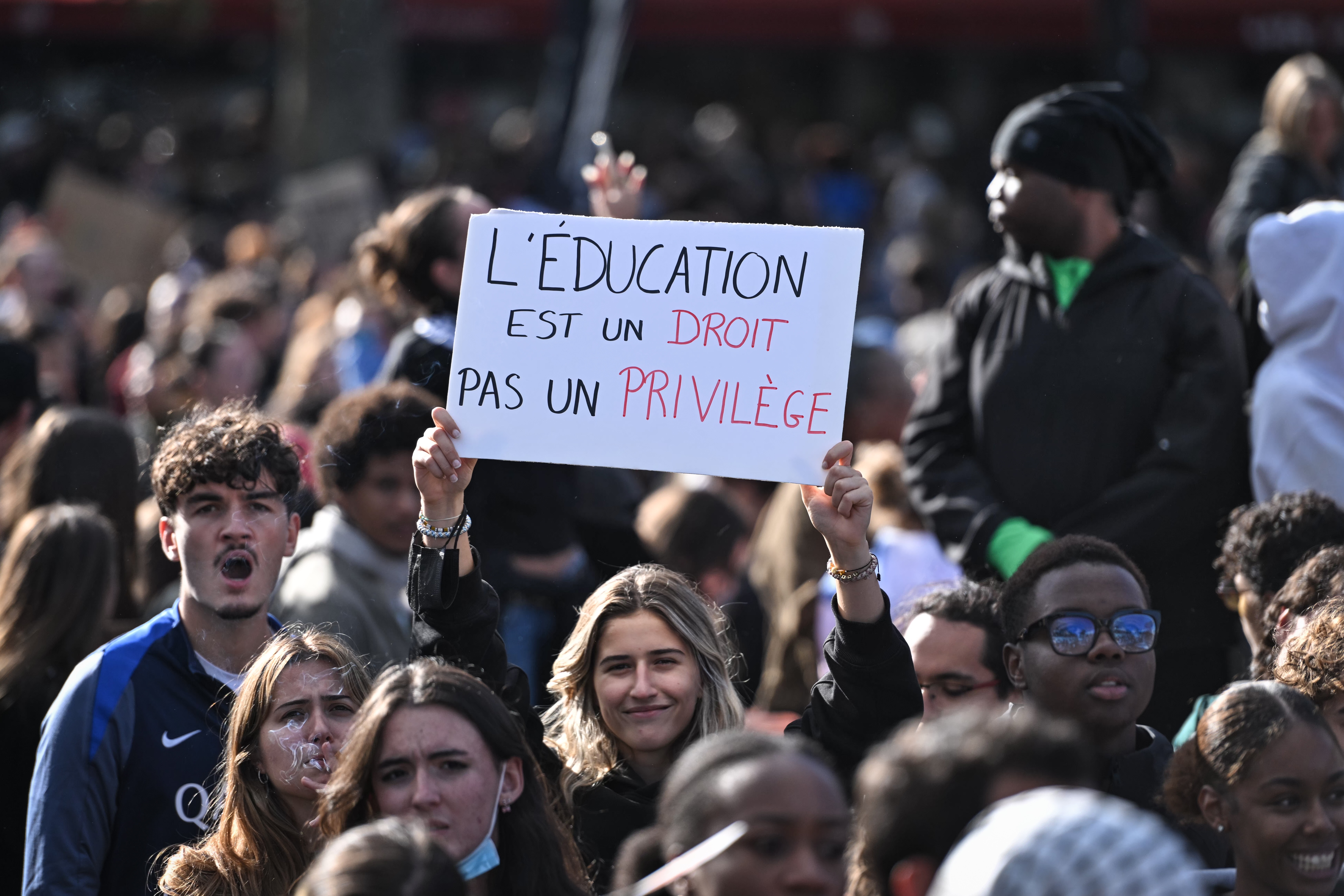 Protester with placard ‘Education is a right, not a privilege’